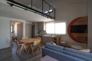 a living room with a blue couch and a table at The Olive Grove Escape in Mitika