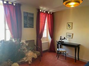 a living room with red curtains and a piano at O et Terre, gite ressourcement bains spa cryo sauna et foret in Dormelles +26 photos