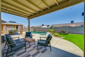 a patio with chairs and a table and a pool at Pet-Friendly Yuma Home with Private Yard and Pool! in Fortuna