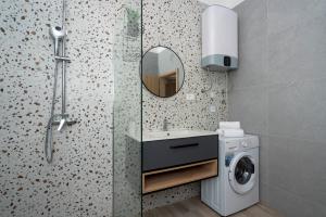 a bathroom with a shower and a washing machine at Luxury apartments Nicole in Trogir +85 photos