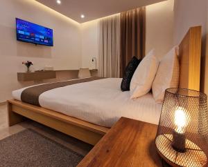 Postel nebo postele na pokoji v ubytování Sveltos Residence Suites