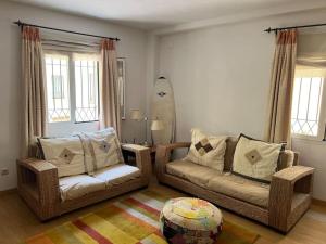 a living room with two couches and a surfboard at GINVA - Dúplex en Plaza de España in El Puerto de Santa María