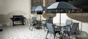 a patio with tables and chairs and a piano at Al Hada Hills Residential Unit in Al Hada