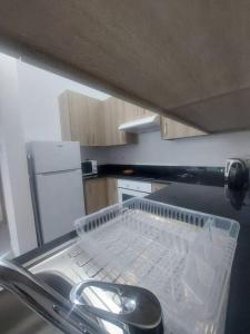 a kitchen with a dish drying rack in a dishwasher at Luxury 2 bedroom apartment in Larnaka +4 photos