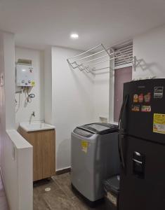 a kitchen with a refrigerator and a sink at HERMOSO y CÓMODO APARTAESTUDIO SABANETA in Sabaneta