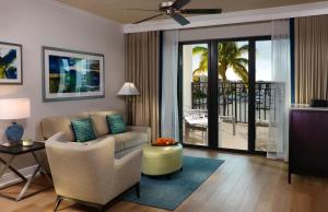 a living room with a couch and a table at Naples Bay Resort and Marina in Naples