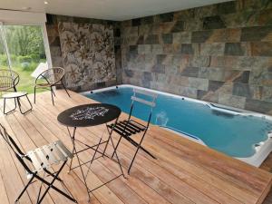 a pool with chairs and a table in front of it at Escapade Romantique à Saint Omer-Espace Totalement Privatisé Avec Terrasse in Saint-Omer