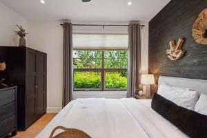 a bedroom with a large bed and a window at Tremblant Prestige - Les Eaux 223-4 in Mont-Tremblant +23 photos