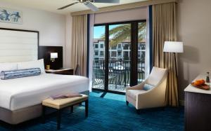 a hotel room with a bed and a balcony at Naples Bay Resort and Marina in Naples
