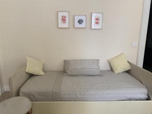 a bed in a room with three pictures on the wall at Sapore di Sale in Salerno