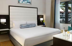 a large white bed in a hotel room at Naples Bay Resort and Marina in Naples