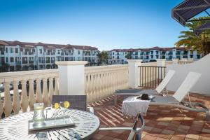 a balcony with a table and chairs and some buildings at Naples Bay Resort and Marina in Naples