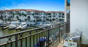 a balcony with a view of a marina with boats at Naples Bay Resort and Marina in Naples