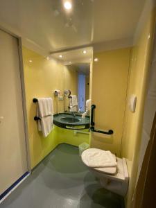 a bathroom with a toilet and a sink at Brit Hotel Marvejols in Marvejols