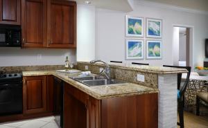 a kitchen with a sink and a stove at Naples Bay Resort and Marina in Naples