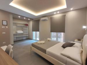 a large bedroom with a large bed and a table at Luma Casa Vacanze Castelbuono in Castelbuono