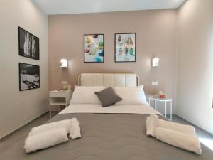 a bedroom with a large white bed with two pillows at Luma Casa Vacanze Castelbuono in Castelbuono