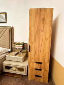 a bedroom with a wooden door next to a bed at Golden Escape - Charming Studio in Prime Location in Craiova