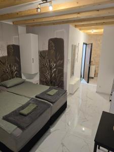 a bedroom with a bed in a room with marble floors at Apartment Rose Cres 4 in Cres