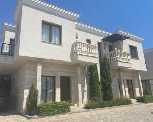 a large white house with balconies on a street at Majestic Villas Pomorie Park in Sarafovo