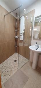 a bathroom with a shower and a sink at El Jardin Secreto in Oria