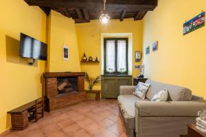 a living room with a couch and a flat screen tv at Green Home in Ronciglione
