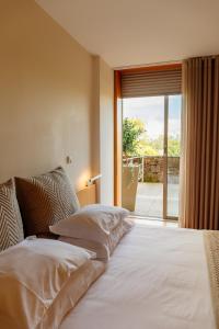 Postel nebo postele na pokoji v ubytování Axis Ponte de Lima Golf Resort Hotel + 34 fotografií