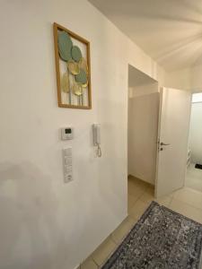a white bathroom with a phone on the wall at Das Schubert in Gmunden +51 photos