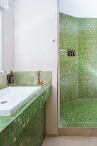 a bathroom with a sink and a shower at Fanhams Hall, Exclusive Collection in Ware