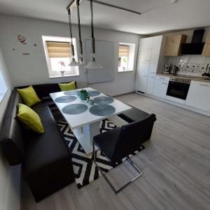 a living room with a white table and a couch at Ferienparadies Haus Monica in Weikertsham