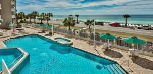 a swimming pool with a view of the beach at Majestic Sun 0303A in Destin