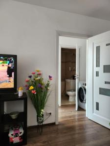 a living room with a vase of flowers on a table at Exceptional Apartment - Gara de Nord in Bucharest