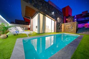 a swimming pool in the backyard of a house at Villa Cacemar Salobre Golf in Las Palmas de Gran Canaria