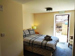 a bedroom with a bed with a teddy bear on it at St Margaret's Hope Backpackers Hostel in Orkney