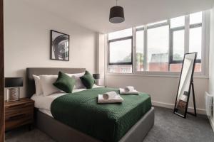 a bedroom with a bed with two towels on it at 1 Bed Modern Central Preston Apartment in Preston