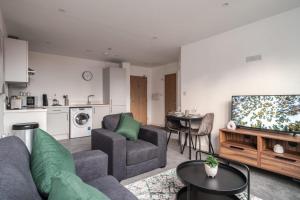 a living room with a couch and a tv at 1 Bed Modern Central Preston Apartment in Preston