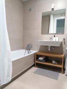 a bathroom with a tub and a sink and a mirror at Holiday Apartment in Abades with Pool in Santa Cruz de Tenerife