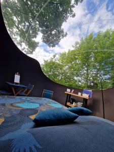 a bedroom with a large bed with blue pillows at Les nuits de Cassiopee in Sorde-lʼAbbaye