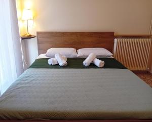 a bed with two towels on top of it at Rigas Apartment in Artemida