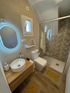 a bathroom with a sink and a toilet and a shower at Casadeira de Mucha in Camariñas