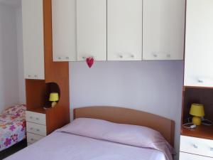 A bed or beds in a room at Homiday - Residence Micaene