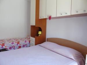 A bed or beds in a room at Homiday - Residence Micaene