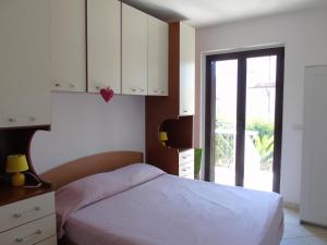 A bed or beds in a room at Homiday - Residence Micaene