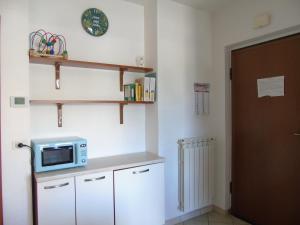 A kitchen or kitchenette at Homiday - Residence Micaene
