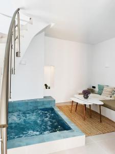 a pool of water in a room with a staircase at Deos luxury house in Ios Chora
