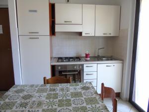 A kitchen or kitchenette at Homiday - Residence Micaene