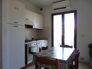 A kitchen or kitchenette at Homiday - Residence Micaene