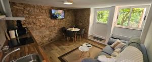 a living room with a couch and a table at Casadeira de Mucha in Camariñas