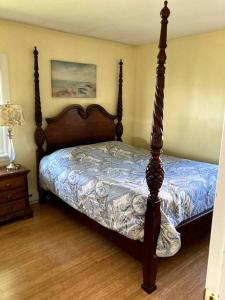 a bed with a wooden frame in a bedroom at The Buoys in Gloucester