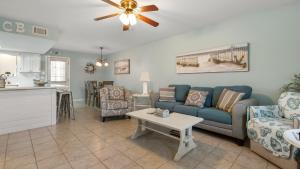 a living room with a couch and a table at Beach access close to Walmart, Bowling,skating and Game room in Panama City Beach